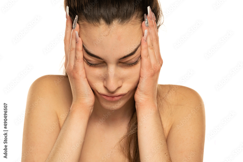 young woman full of boredom leaned her head on her hand on a white young woman full of boredom leaned her head on her hand on a white