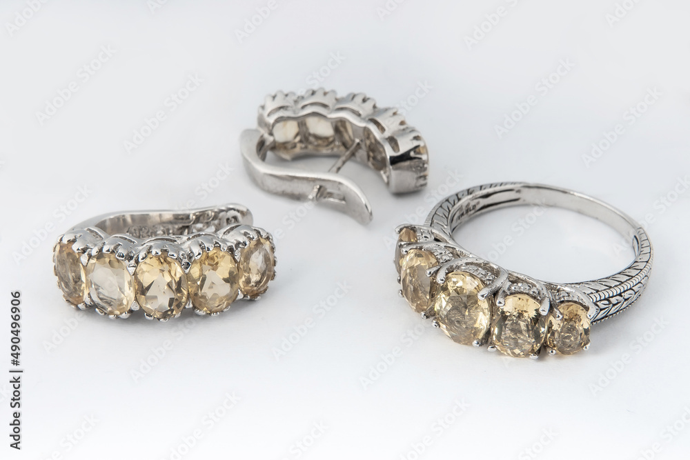 Elegant jewelry set of white gold ring, necklace and earrings with diamonds. Silver jewellery set with gemstones. Product still life concept Elegant jewelry set of white gold ring, necklace and earrings with diamonds. Silver jewellery set with gemstones. Product still life concept
