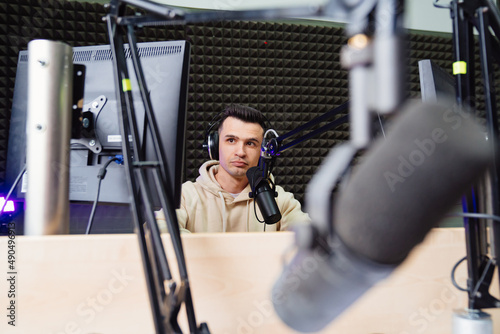 A sports speaker is conduct a live broadcast in a radio studio. sports analyst. photo
