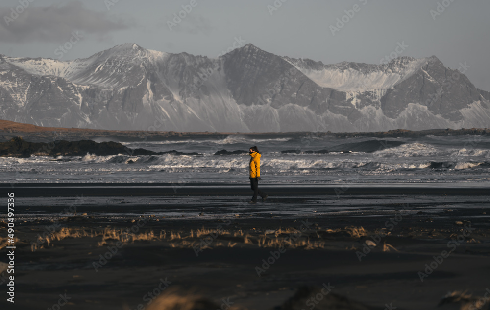 woman walking on stokksnes black beach