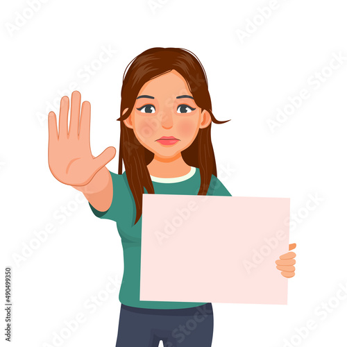 beautiful young woman holding blank poster or signboard showing stop hand palm gesture with serious and confident facial expression