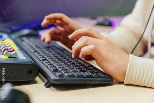 Men's hands type on a computer keyboard. remote work and online learning. 