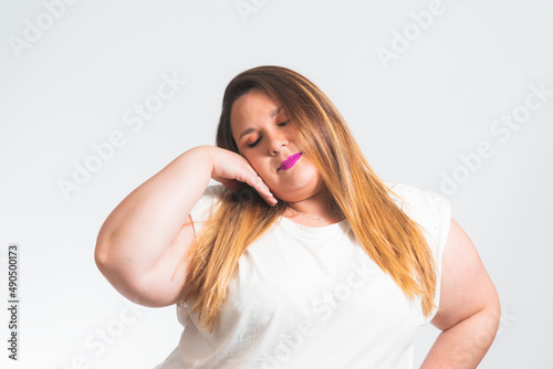 chubby young woman loving herself with her eyes closed