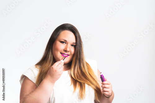 plus size model putting on lipstick