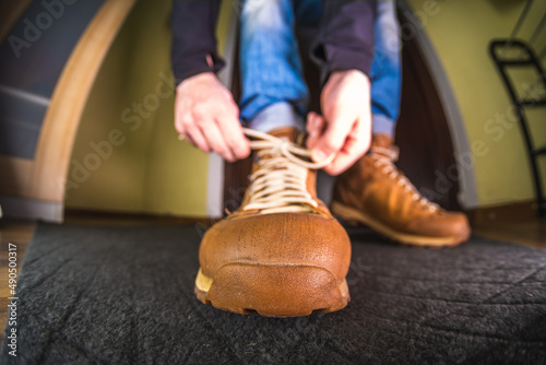 A man ties his shoelaces. Close-up