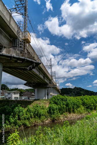 railway bridge crosses a stream in countryside, JAPAN.