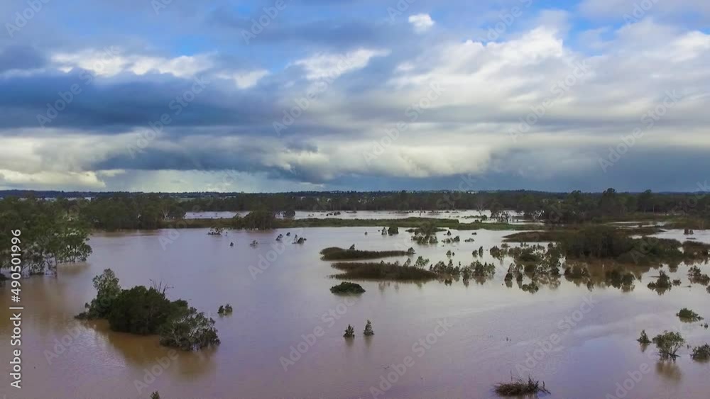 Queensland, NSW, Australia, February floods - dramatic aerial drone shot rising over inundated flood plains in Brisbane, under dramatic stromy skies Queensland, NSW, Australia, February floods - dramatic aerial drone shot rising over inundated flood plains in Brisbane, under dramatic stromy skies