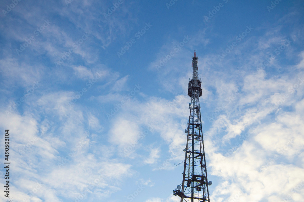 a television cell tower on the border of two states against a blue sky, the front and back backgrounds are blurred with a bokeh effect a television cell tower on the border of two states against a blue sky, the front and back backgrounds are blurred with a bokeh effect