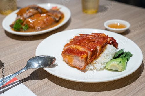 Barbecue pork combination. char siew and roasted pork with rice on wooden Table. Hong kong cuisine, Chinese cuisine photo