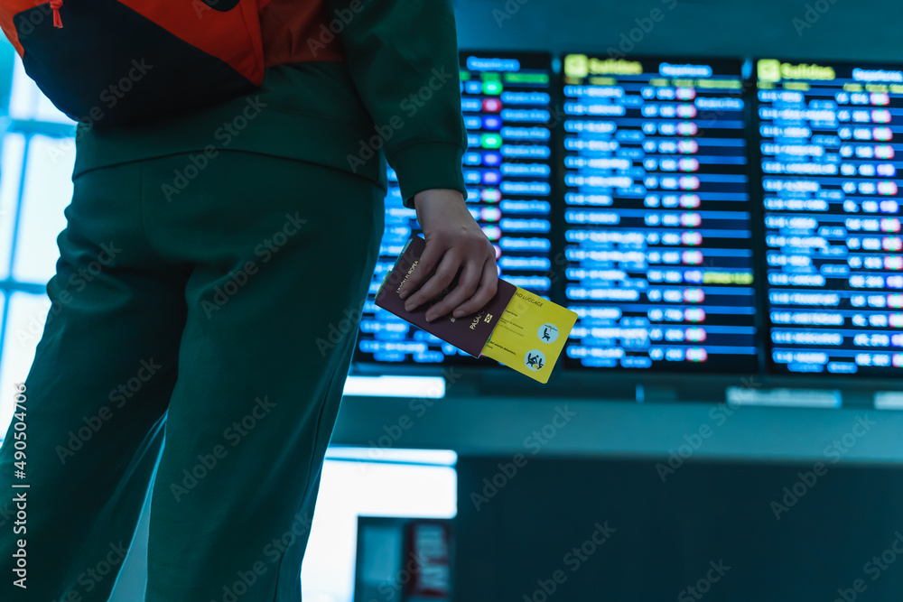 woman at the airport looking at the screens for her flight