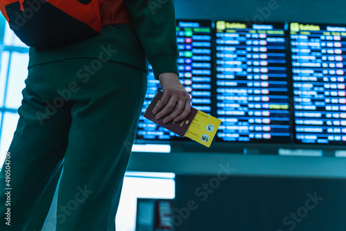 woman at the airport looking at the screens for her flight