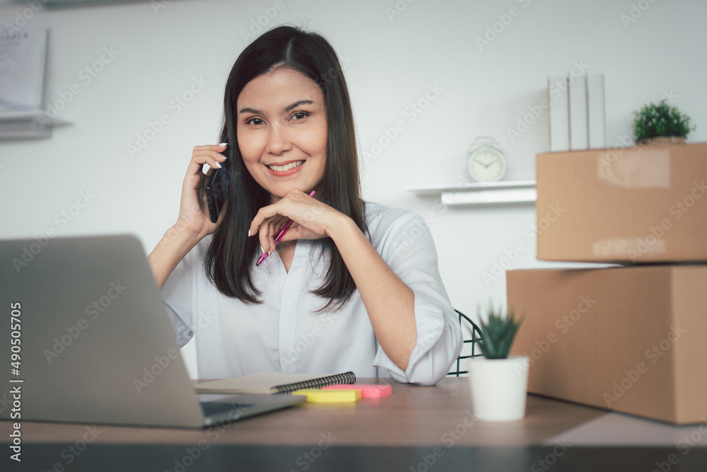 Happy young Asian woman entrepreneur, talk with a supplier and Smile for sale success of online shopping store at home office, Concept of the merchant, small business, online business, and eCommerce. Happy young Asian woman entrepreneur, talk with a supplier and Smile for sale success of online shopping store at home office, Concept of the merchant, small business, online business, and eCommerce.