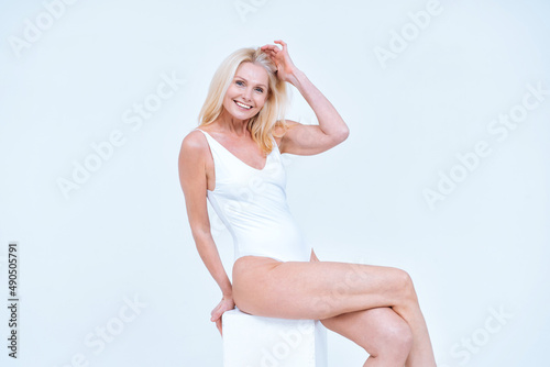 Beautiful middle aged woman posing in lingerie for a body positive and beauty photoshooting photo
