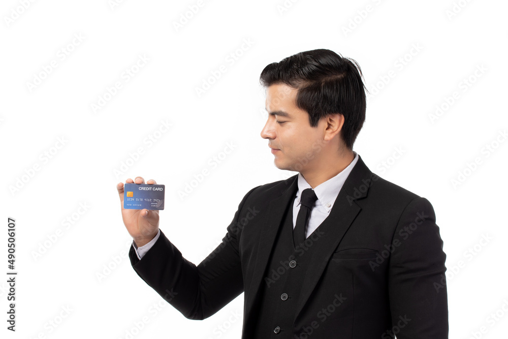Handsome business man in black suit holding credit card isolated on white background. Business, technology, ecommerce and online payment concept. Handsome business man in black suit holding credit card isolated on white background. Business, technology, ecommerce and online payment concept.
