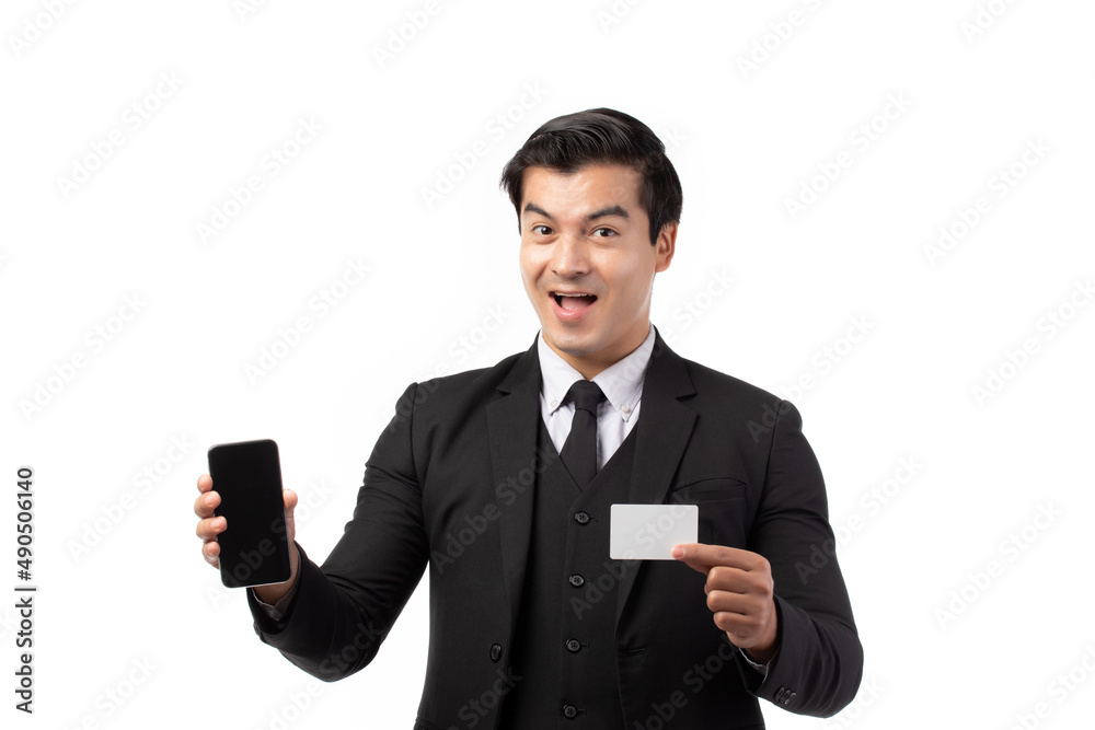 Handsome business man in black suit holding credit card and using smartphone for online shopping isolated on white background. Business, technology, ecommerce and online payment concept. Handsome business man in black suit holding credit card and using smartphone for online shopping isolated on white background. Business, technology, ecommerce and online payment concept.