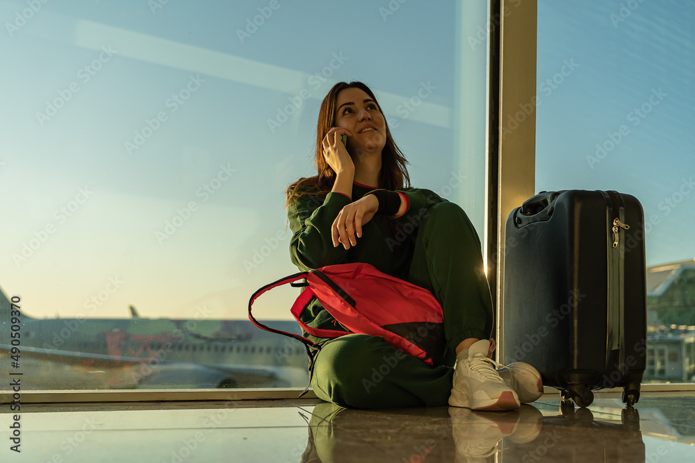 Woman calling by phone at the airport