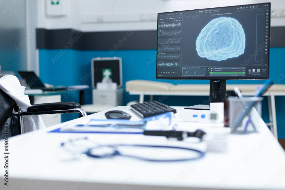 Computer standing on table having brain radiography on screen during ...