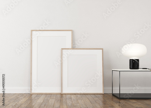 Front view, white wall, empty canvas, 3d illustration. Two empty canvases, front view decorated with table and lighted table lamp