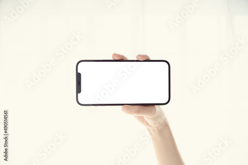 The hand holding the phone horizontally