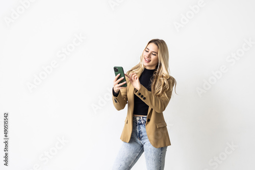 Woman using a mobile phone isolated on a white background