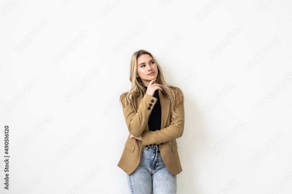 Thoughtful young woman thinking and looking away over white background