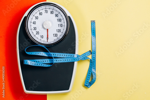 Scales and measuring tape. top view. the concept of excess weight.