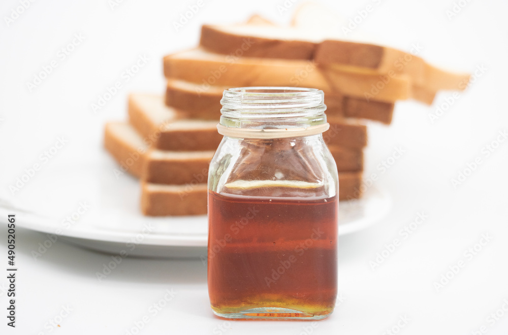 Six slices of bread with honey and honey dipper isolated on white studio background Six slices of bread with honey and honey dipper isolated on white studio background