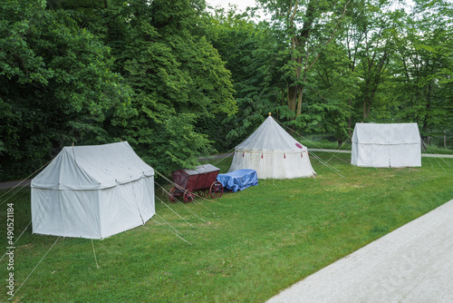 Vintage medieval wagons with food and tents on the background of the forest