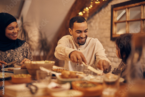 Fototapeta Happy Middle Eastern family enjoys in Ramadan dinner at dining table