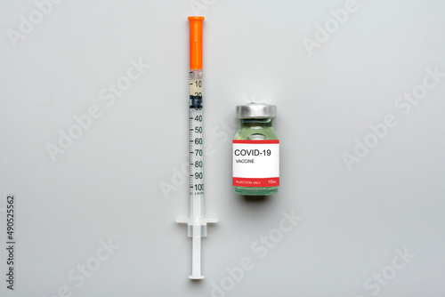 Ampoule with vaccine, syringe isolated on gray background Vaccination against viruses, flu, pneumonia, coronavirus, tuberculosis, covid-19 concept Mock-up Top view Flat Lay