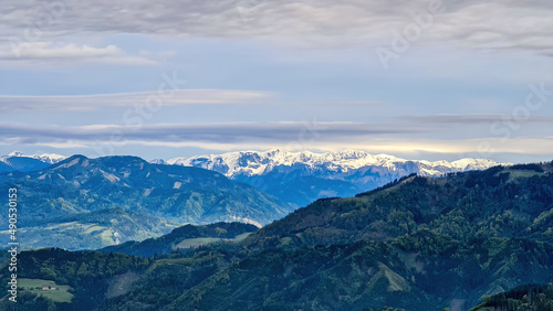 Panoramic view on the Eisenerzer Alps from below mount Roethelstein near Mixnitz in Styria, Austria. Snow capped mountain of the Ennstal Alps beyond the Grazer Bergland in Styria, Austria. Hochtor