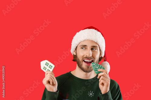 Handsome man in Santa hat w...