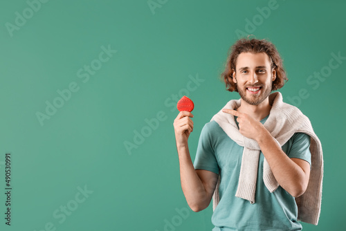 Handsome man pointing at gi...