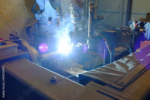 The CNC lathe machine cutting the steel rod .The raw material bar clmaping on the CNC lathe machine
