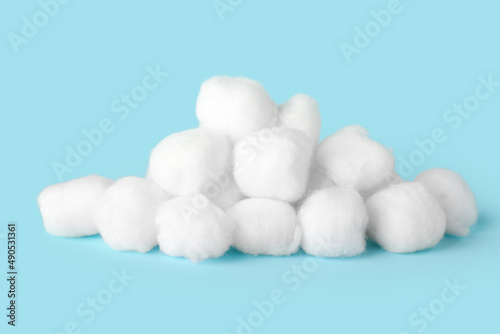 Heap of cotton balls on color background
