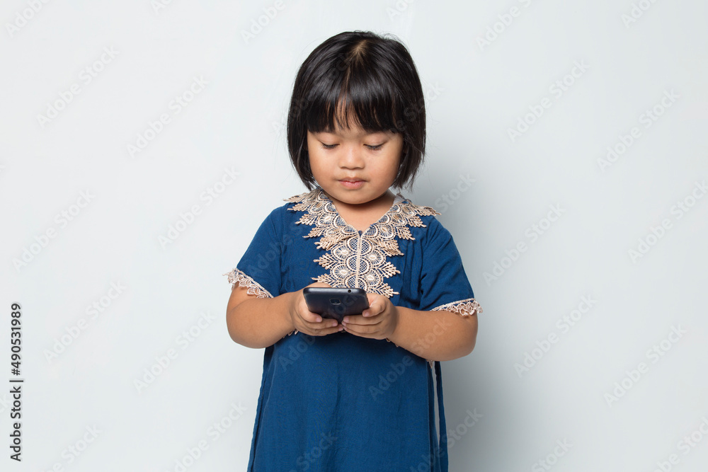 Happy asian little girl using smart phone on white background
Happy asian little girl using smart phone on white background