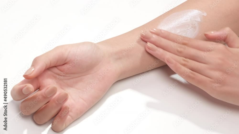 A moment of women using cream on wrist in white background for cosmetic advertising A moment of women using cream on wrist in white background for cosmetic advertising