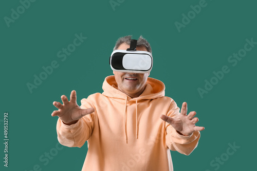 Senior man in VR glasses on...