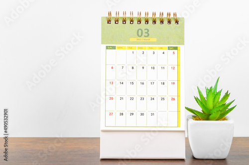 March 2022 desk calendar on wooden background. photo