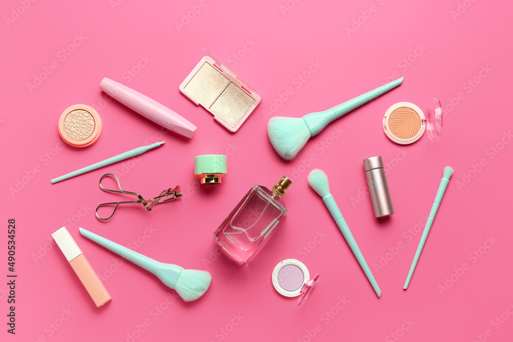 Composition with makeup brushes and cosmetic products on pink background Composition with makeup brushes and cosmetic products on pink background