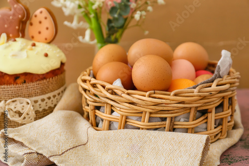 Gift basket with painted Easter eggs on table