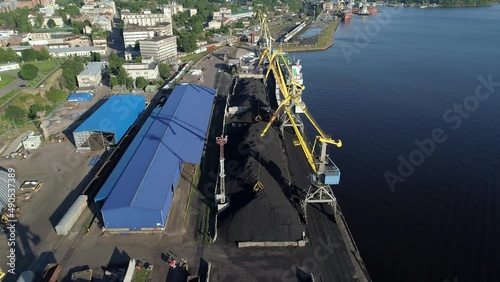 Aerial view of a coal transshipment in the port terminal. View of port cranes and piles of coal. photo