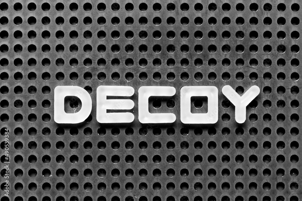 White alphabet letter in word decoy on black pegboard background Stock Photo Adobe Stock