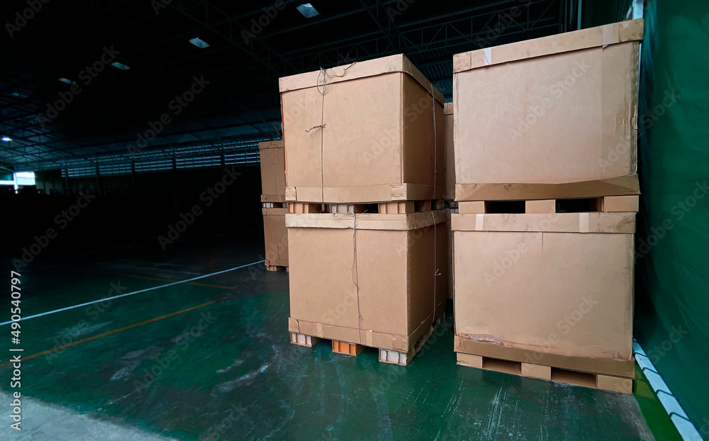 Low light view and copy space. Shadows of Warehouse with lots of old cardboard boxes. Overlapping in the factory. Low light view and copy space. Shadows of Warehouse with lots of old cardboard boxes. Overlapping in the factory.