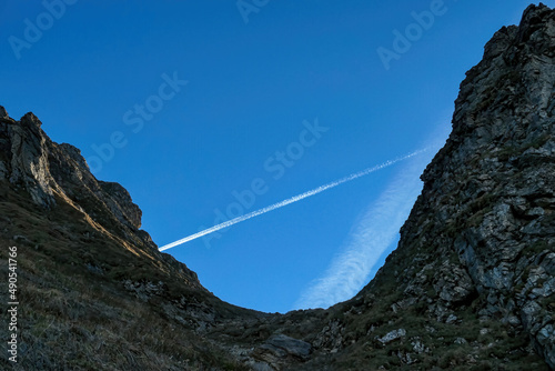 Mountain pass with a massive cliff of mount Eisenerzer Reichenstein in Styria, Austria, Europe. Austrian Alps. Col of  bare mountain ridges of the Ennstal Alps. Rocky landscape.Hiking trail,Wanderlust photo