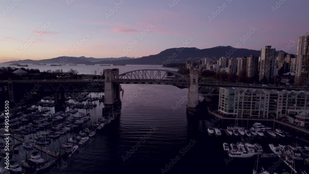 Drone flying over Burrard Bridge at sunset, Vancouver in Canada. Aerial drone panoramic view Drone flying over Burrard Bridge at sunset, Vancouver in Canada. Aerial drone panoramic view