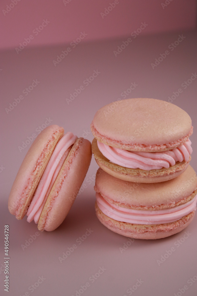 close up of pink macaroons with pink buttercream on pink background close up of pink macaroons with pink buttercream on pink background