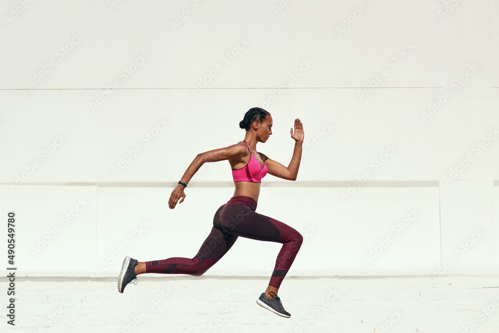 Whether you go slow or fast, just go. Shot of a sporty young woman out running. Whether you go slow or fast, just go. Shot of a sporty young woman out running.