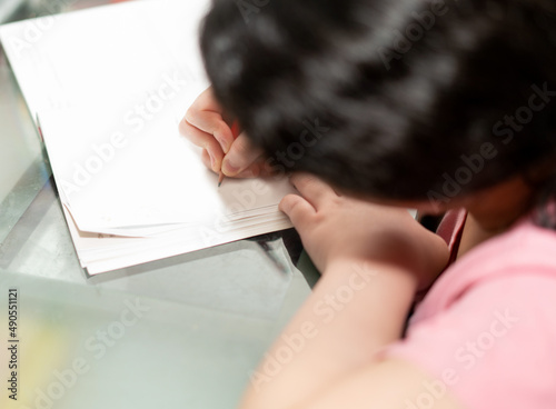 kid young girl writing on book alone