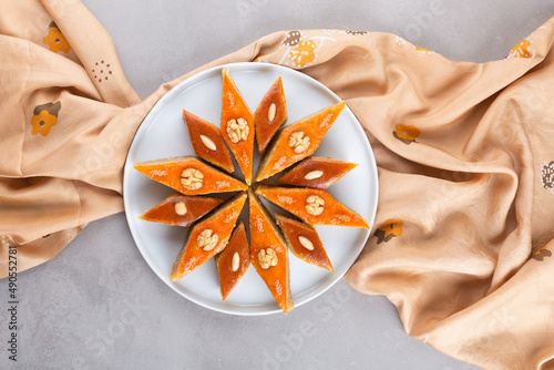 Plate of Azerbaijani national pastries for Novruz - Ganja and Baku style pakhlava on silk scarf kelagai for Novruz, spring equinox and new year celebration in March. Copy space  